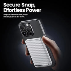 Phone case with power delivery feature held by a hand, dark background